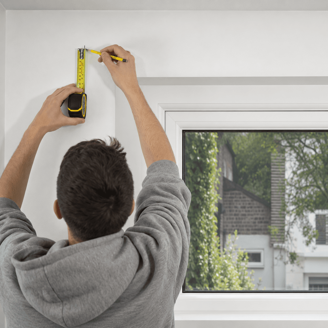 Position each bracket above the window recess and mark fixing holes