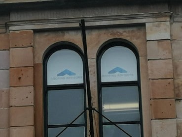 Windows with roller blinds that have printed logos